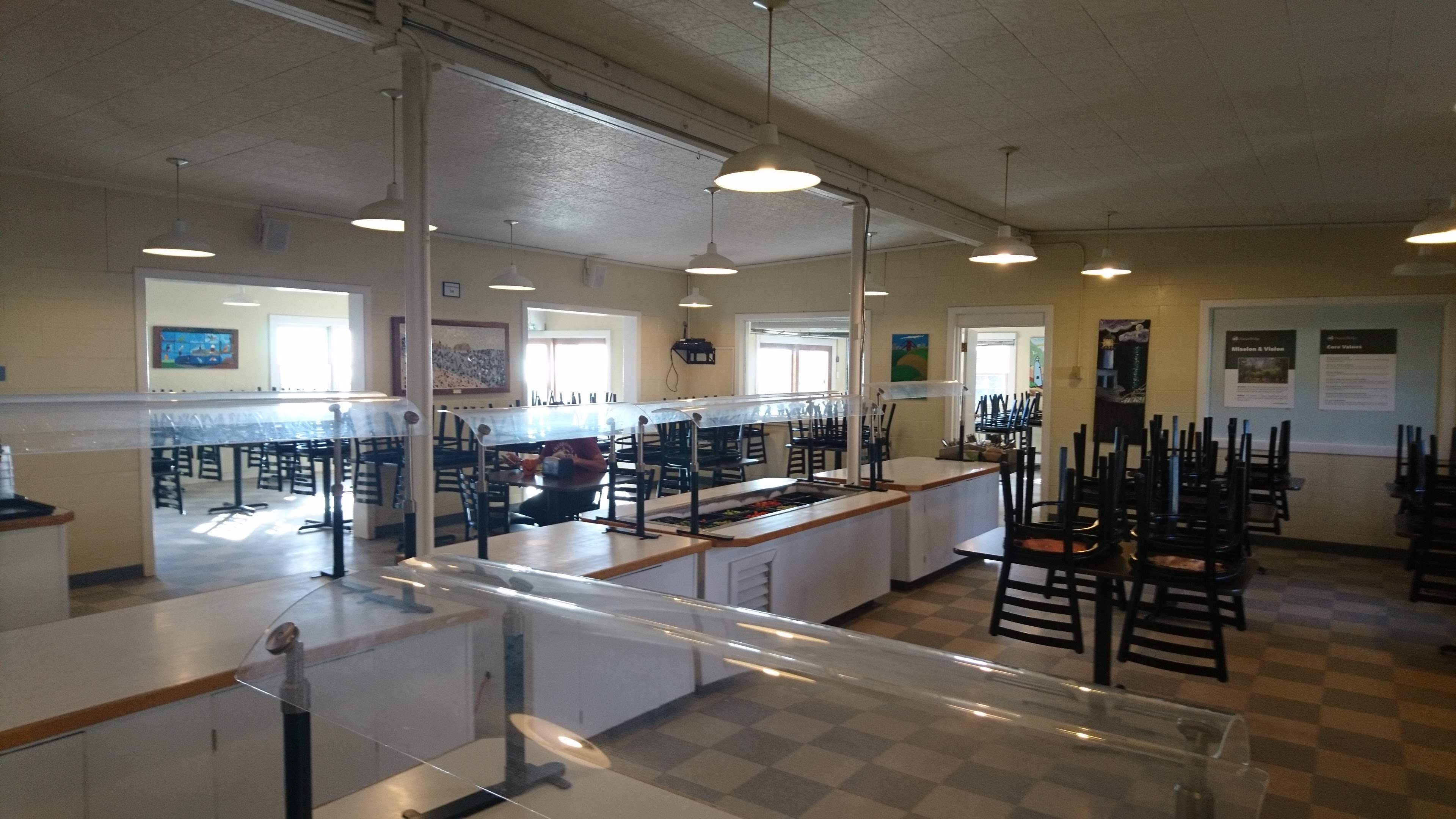 Photo of inside of dining hall. Buffet and several tables.